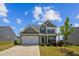 Two-story home featuring stone accents, neutral siding, and a two-car garage at 115 Bourne Dr, Franklinton, NC 27525