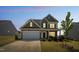 Charming two-story home with a brick and siding exterior and a two-car garage at 115 Bourne Dr, Franklinton, NC 27525