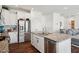 A light and airy kitchen featuring a large island and stainless steel appliances at 115 Bourne Dr, Franklinton, NC 27525