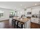 Open kitchen with granite countertops, an island with barstool seating, and modern appliances at 115 Bourne Dr, Franklinton, NC 27525