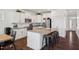 Kitchen featuring a central island with seating, stainless steel appliances, and white cabinets at 115 Bourne Dr, Franklinton, NC 27525
