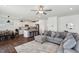Open-concept living area with a kitchen island, modern white cabinets, and a comfortable gray sectional sofa at 115 Bourne Dr, Franklinton, NC 27525