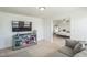 Open concept living space featuring a blue cabinet, TV, and view into an adjacent bedroom at 115 Bourne Dr, Franklinton, NC 27525