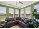 Cozy sunroom featuring a comfortable sectional sofa, green walls, and bright natural light at 115 Bourne Dr, Franklinton, NC 27525