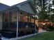 Backyard featuring a screened porch, pergola, and ambient lighting for outdoor enjoyment at 115 Oak Leaf Trl, Youngsville, NC 27596