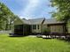 Spacious backyard with a covered porch, patio area, and a well-maintained lawn at 115 Oak Leaf Trl, Youngsville, NC 27596