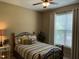 Cozy bedroom featuring natural light, colorful bedding, and a comfortable sleeping space at 115 Oak Leaf Trl, Youngsville, NC 27596