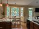 Sunny breakfast nook featuring a bay window, hardwood floors, and direct access to the outdoor space at 115 Oak Leaf Trl, Youngsville, NC 27596