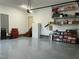 Garage featuring painted epoxy floors, storage shelving, and space for organization at 115 Oak Leaf Trl, Youngsville, NC 27596