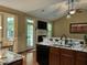 Modern kitchen with granite countertops, stainless steel appliances, and an open view into the living room at 115 Oak Leaf Trl, Youngsville, NC 27596