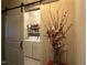 Charming laundry room with sliding barn door entrance and ample storage space at 115 Oak Leaf Trl, Youngsville, NC 27596