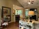 Open-concept living area with a granite bar, hardwood floors, fireplace, and seamless flow to the kitchen at 115 Oak Leaf Trl, Youngsville, NC 27596