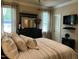 Inviting main bedroom with plush pillows, decorative lamps, and a mounted television at 115 Oak Leaf Trl, Youngsville, NC 27596
