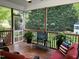 Relaxing screened-in porch featuring comfortable seating and a TV for outdoor entertainment at 115 Oak Leaf Trl, Youngsville, NC 27596