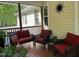 Relaxing screened porch with comfortable seating, decorative accents, and a view of the surrounding greenery at 115 Oak Leaf Trl, Youngsville, NC 27596