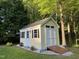 Charming backyard shed with ample storage space and a convenient access ramp at 115 Oak Leaf Trl, Youngsville, NC 27596