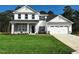 Charming two-story home featuring a manicured lawn, attached two-car garage and classic architectural design at 115 River Chapel Dr, Fuquay Varina, NC 27526
