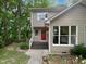 Charming two-story home with a inviting red front door and well maintained landscaping at 122 Mallard Ct, Chapel Hill, NC 27517