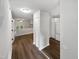 Hallway with wood floors leading to bright kitchen and living room with neutral walls at 122 Mallard Ct, Chapel Hill, NC 27517