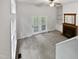 Bright living room featuring a fireplace, built in shelves, and French doors to the outside at 122 Mallard Ct, Chapel Hill, NC 27517
