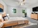 Spacious main bedroom with two windows, neutral colors, and a ceiling fan at 122 Mallard Ct, Chapel Hill, NC 27517