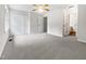 Large main bedroom with carpeted floor, fan, and multiple doors to closet and bathroom at 122 Mallard Ct, Chapel Hill, NC 27517