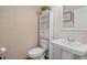 Half bathroom features a toilet, sink, and built-in storage shelves with neutral tile at 1220 Marbank St, Wake Forest, NC 27587