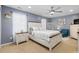 Cozy bedroom with a ceiling fan, ample natural light, and a classic white bed frame and furnishings at 1220 Marbank St, Wake Forest, NC 27587