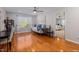 Spacious bonus room with hardwood floors, ceiling fan and a large window showing the backyard at 1220 Marbank St, Wake Forest, NC 27587