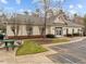 A single-story clubhouse features a symmetrical design, light beige siding, and a brick foundation accent, creating an inviting community space at 1220 Marbank St, Wake Forest, NC 27587