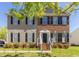 Charming two-story home with a brick and siding facade and manicured lawn at 1220 Marbank St, Wake Forest, NC 27587