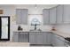 Modern kitchen features gray cabinets, granite counters, stainless steel appliances, and a subway tile backsplash at 1220 Marbank St, Wake Forest, NC 27587