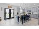 Bright, open kitchen with an island, gray cabinets, stainless steel appliances, and access to outdoor space at 1220 Marbank St, Wake Forest, NC 27587