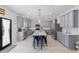 Spacious kitchen featuring gray cabinets, a granite island with seating, and stainless steel appliances at 1220 Marbank St, Wake Forest, NC 27587