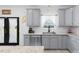 Modern kitchen features gray cabinets, granite counters, stainless steel appliances, and a subway tile backsplash at 1220 Marbank St, Wake Forest, NC 27587