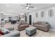 Open living room with a kitchen view, neutral furniture, and tile flooring at 1220 Marbank St, Wake Forest, NC 27587