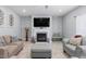Cozy living room with a fireplace, neutral-toned furniture, and tile flooring at 1220 Marbank St, Wake Forest, NC 27587