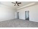 Spacious carpeted bedroom featuring a ceiling fan and ample natural light from the doorway entries at 1234 Pioneer Lot 3 Dr, Sanford, NC 27330
