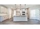 Bright kitchen featuring a large center island, stainless steel appliances, and modern pendant lighting at 1234 Pioneer Lot 3 Dr, Sanford, NC 27330