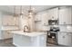 Kitchen with white cabinets, granite counters, stainless appliances, and central island with pendant lighting at 1234 Pioneer Lot 3 Dr, Sanford, NC 27330