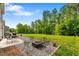 Expansive backyard includes a gravel firepit area and ample green space for recreation and relaxation at 1287 Salters St, Burlington, NC 27215
