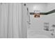 This bathroom has a full tub, shower curtain and white walls with accent colors at 1287 Salters St, Burlington, NC 27215