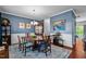 Elegant dining room with wainscoting, beautiful blue walls, hardwood floors, and a stylish chandelier at 1287 Salters St, Burlington, NC 27215