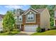 Charming two-story home featuring mixed brick and siding, a manicured lawn, and an attached two-car garage at 1287 Salters St, Burlington, NC 27215