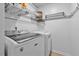 Bright laundry room featuring modern washer and dryer, shelving and convenient storage solutions at 1287 Salters St, Burlington, NC 27215