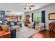 Open-concept living area with hardwood floors, large windows, and comfortable seating. A seamless transition to kitchen at 1287 Salters St, Burlington, NC 27215