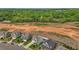 Aerial view of homes near green spaces, construction area, and dense woodlands at 135 Campaign Dr, Mebane, NC 27302