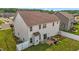 A bright, two-story home featuring an outdoor patio and spacious, fenced in backyard at 135 Campaign Dr, Mebane, NC 27302