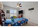Bright bedroom with ceiling fan, blue star patterned bedding, and a large window at 135 Campaign Dr, Mebane, NC 27302