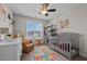 Charming Bedroom with crib, ceiling fan, area rug and an abundance of natural light at 135 Campaign Dr, Mebane, NC 27302